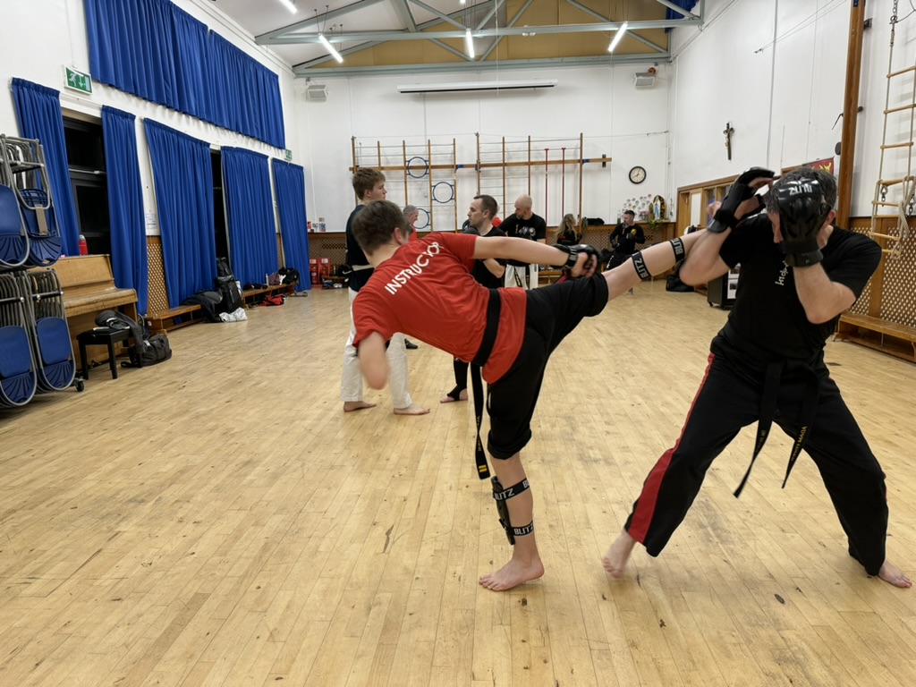 Two martial artists engaged in impact sports
